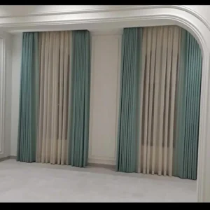 Structured Roman-fold curtains combining tidy lines with soft, layered fabric tones.